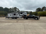 Black truck towing a large RV on a cloudy day with a DW58 Swivelwheel